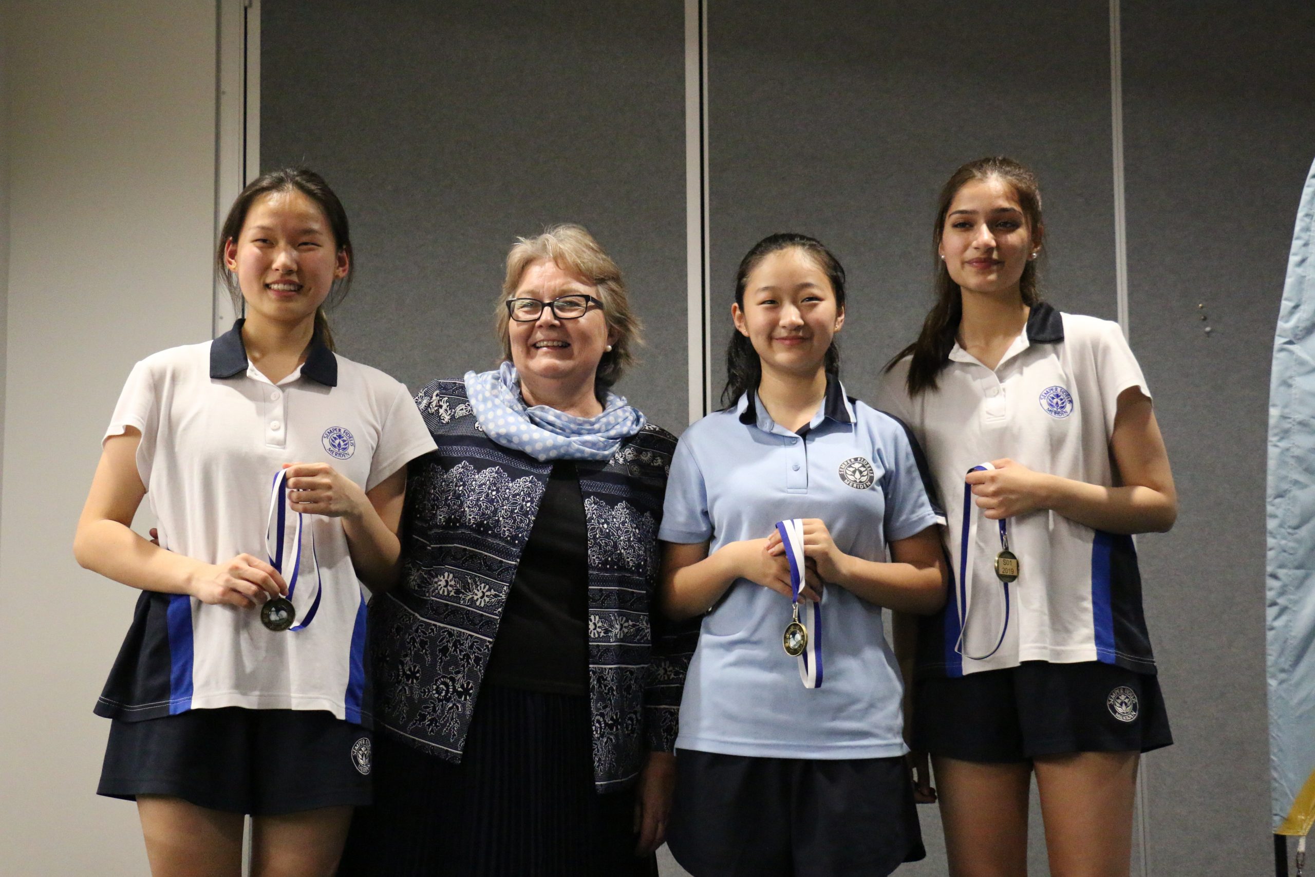 2019_Sport_Badminton_Three students in sports uniform Meriden